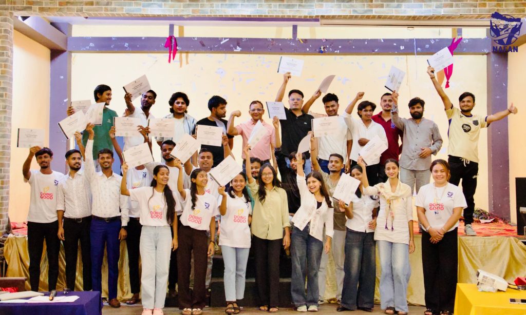 Participants cheering and holding up certificates in the hall